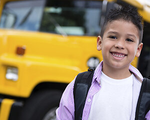 boy in front of school bus